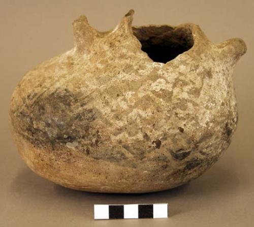 "oval vessel with 2 lugs, broken rim, remnants of geometric design"