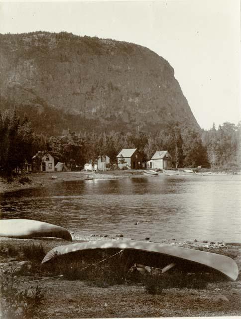 Village houses and canoes beside Mt. Kineo.