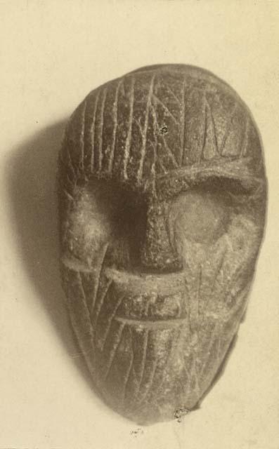 Soapstone effigy of human face.