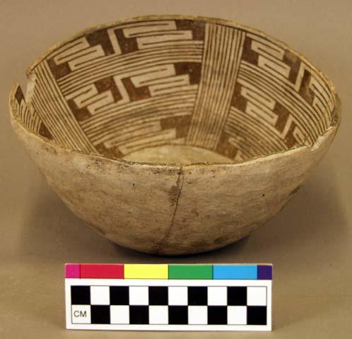 Ceramic bowl, plain exterior, black on grey interior, steep walls, mended