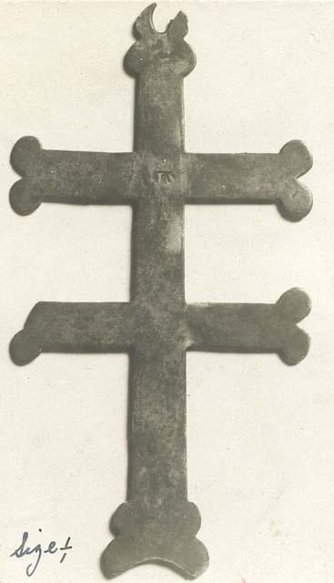 Artifact in shape of cross but with 2 horizontal lines from Ojibwa grave