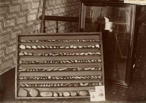 Shelf lined with stone tools.Collection of Harlan L. Smith, Saginaw Michigan