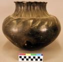 Ceramic jar, black burnished exterior, scalloped rim, incised neck & body