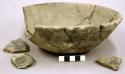 Ceramic bowl with scalloped pattern around rim, sherds, repaired, partial