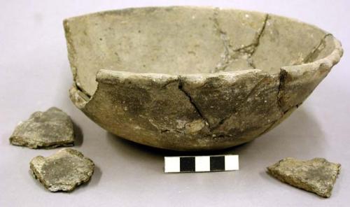 Ceramic bowl with scalloped pattern around rim, sherds, repaired, partial