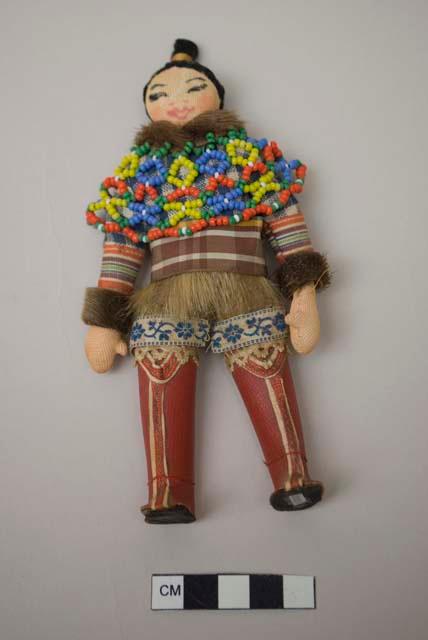 Female doll with beaded yoke and red boots
