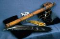 Wooden flute. With leather, beads, and large eagle feather.