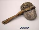 Large stone hammer hafted in a wood handle