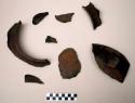 Ceramic rim & body sherds, strap handle, buff slip, burnt