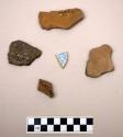 Tray of pottery sherds, some marked “PV 48-102-107 road,” some marked“across fro