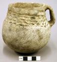Plain and corrugated pottery jug