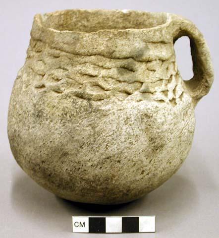 Plain and corrugated pottery jug