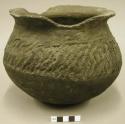 Ceramic jar, corrugated shoulder, sherds missing from flared rim, cracked base