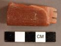 Ground stone, pipe, notched decoration, incised arrow, catlinite