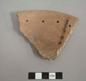 Perforated plate sherd with 4 perforations ca. 1.7 cm. from rim edge. redware