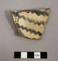 Rim sherd. interior black on white, exterior smooth rim band. below band is corrugated. gila polychrome ?