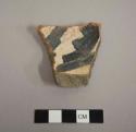 Body sherd from a bowl. Interior is decorated with a linear and geometric black-on-white design, the exterior is slipped red - gila polychrome