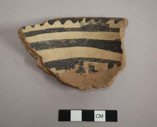 Rim sherd from a hemispherical bowl, rounded base, flared rim, interior black-on-white design, exterior red slip - gila polychrome.