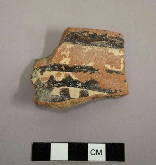 Ceramic rim sherd of a jar. Exterior has linear design of black and white, red slip on rim - gila polychrome?