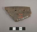 Perforated plate fragment; two perforations (1.2 cm.) from edge on raised rim; third perforation evident along edge of sherd; brownware.