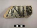 Rim sherd of a bowl, interior is decorated with a black on white linear and geometric design, exterior is slipped red - gila polychrome
