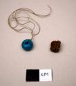 Glass, bead, round, blue, on tan thread with resin fragment