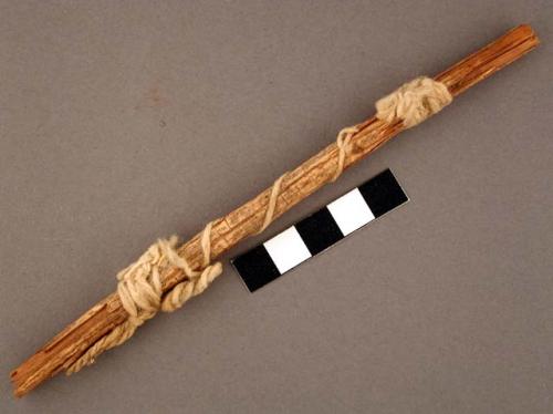 Wood shaft fragment, wrapped in white twine