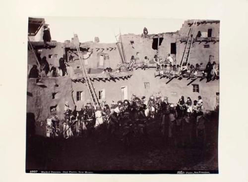 Masked Zuni dancers at mixed dance. Shows mudheads, rain dancers, and ayuhuda.