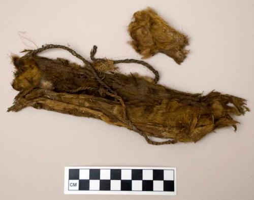 Hide fragments with fur, showing repair stitching & twine fragments