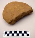 Raw material (pigment?), shaped like a round stone, and broken; with finger impr