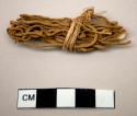 Small bundle of twigs, wrapped in fiber, Secured with wire after excavation
