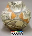 Polychrome jar. Orange and black on white. Geometric and curvilinear designs