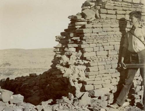 Section of wall of Pueblo Alto with Alfred Tozzer in foreground