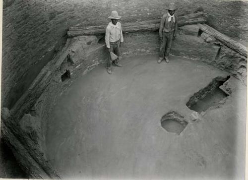 Two Pueblo Indian men standing in Kiva L