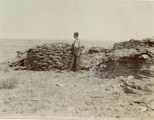 On Monument Point; man standing next to circular stone structure
