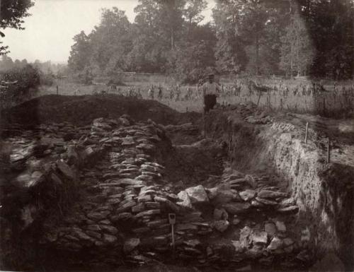 Cut through embankment north end, showing stones under burnt clay.