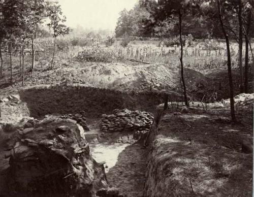 Wall of stones with opening under burnt clay