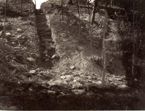 Excavation up the west side of hill through the burnt clay to the stones below it