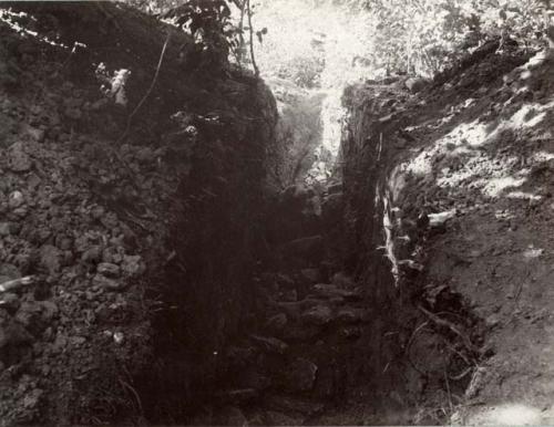 Second trench on side of hill showing stones, artifact walls.