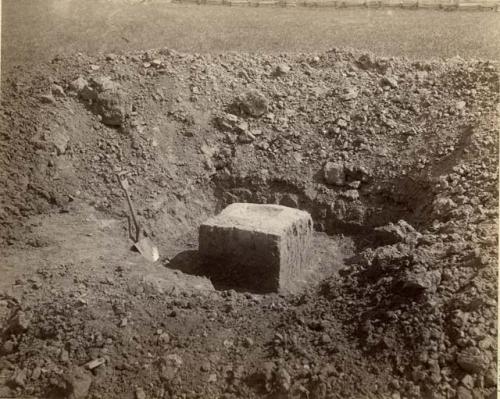 Excavated pit with cube in center.