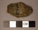 Ground stone, pipe bowl fragment, incised