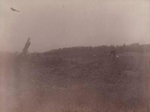 Taylor farm-countryside. Men standing in field.