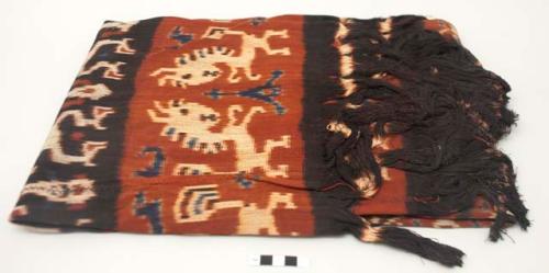Man's shoulder or hip cloth, hinggi; indigo and red with white, red and blue ikat designs of animals facing each other.