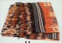 Man's shoulder or hip cloth, hinggi; indigo and red with white, red and blue ikat designs of creatures