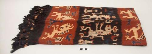 Man's shoulder or hip cloth, hinggi; indigo and red with white, red and blue ikat designs of animals facing each other