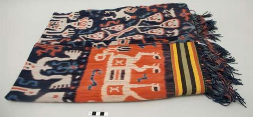 Man's shoulder or hip cloth, hinggi; indigo and red with white, red and light blue ikat designs of head-tree, ancestors, animals