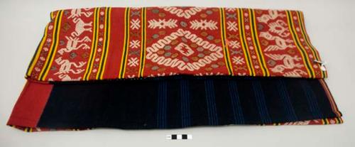 Textile; bands of red, dark blue and yellow with supplementary brocade of animals and designs in yellow, red and white; some of the white brocade has been colored gray and brown; repaired