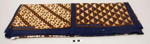 Batik textile sampler with named batik patterns in dark blue, ivory and brown