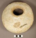 "crusher". circular cobble peckedto shape. wide perforation near one end forms c