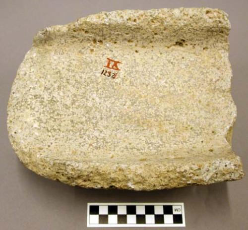 Metate fragment, broken, open-ended trough, raised rim, rounded bottom & sides;